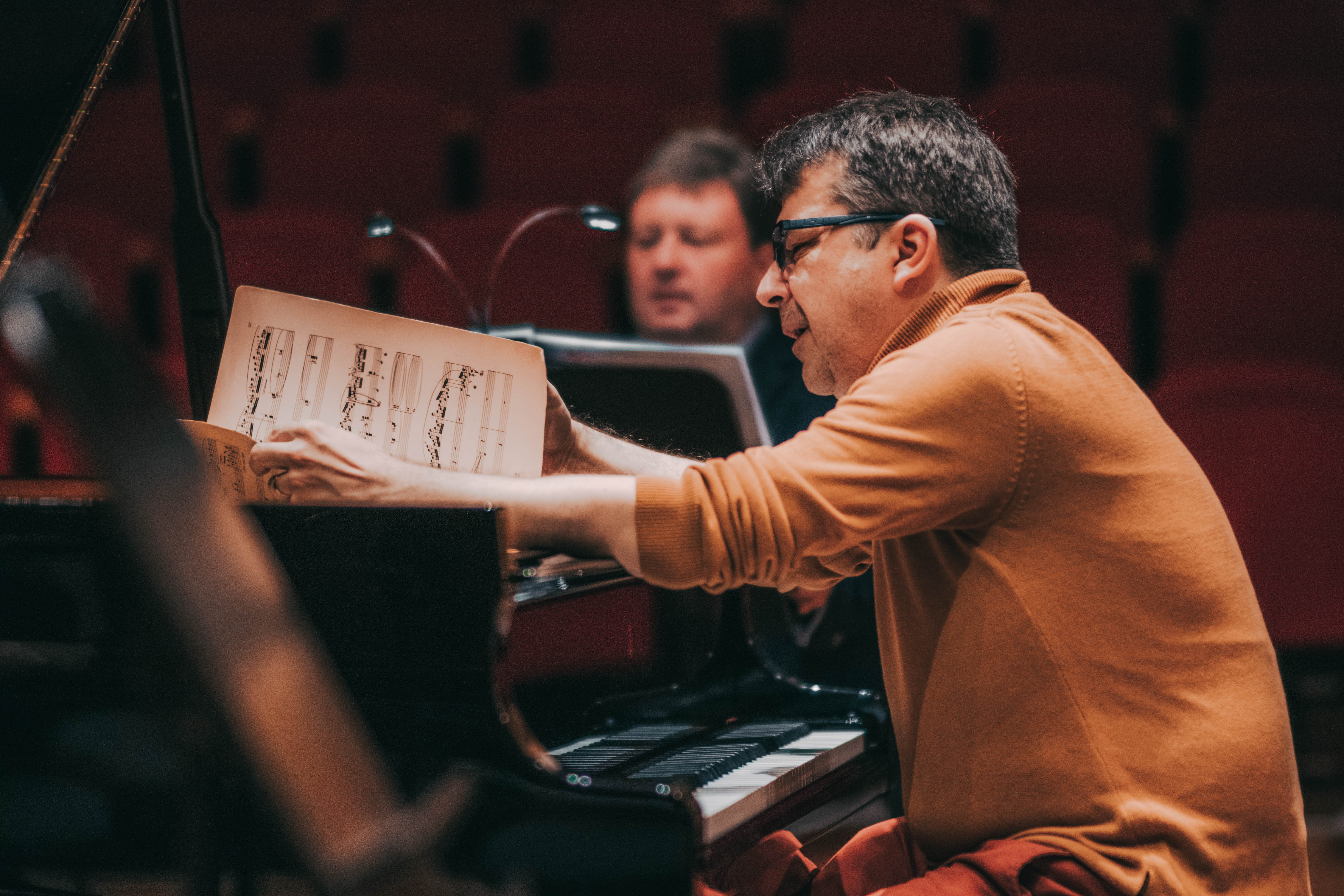Pianist studying the score — close-up